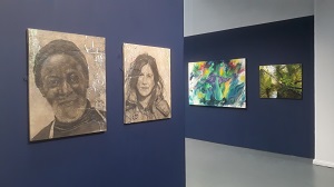 A view of the OPEN exhibition showing two portraits on the left and two landscapes on the right